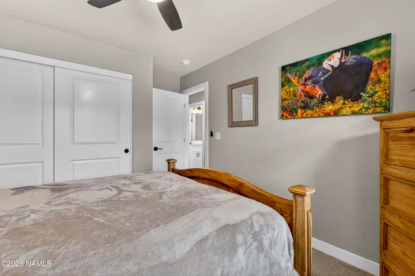 a bedroom with a bed and painting on the wall