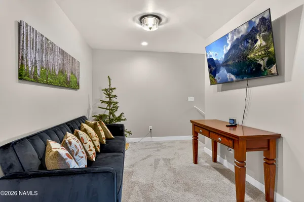 a living room with furniture and a wall painting