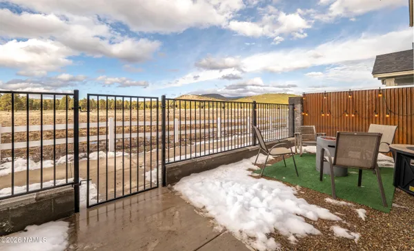 a view of a house with wooden fence