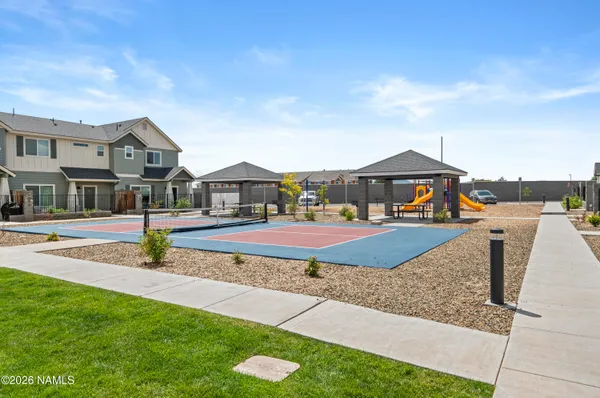 a view of a house with a big yard and large trees