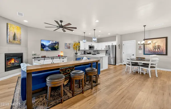 a kitchen with stainless steel appliances a dining table chairs stove a sink and dishwasher
