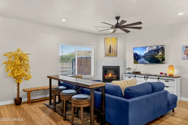 a living room with fireplace furniture and a flat screen tv