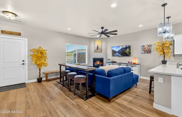 a living room with furniture and wooden floor