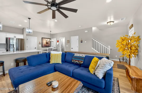 a living room with furniture and a chandelier