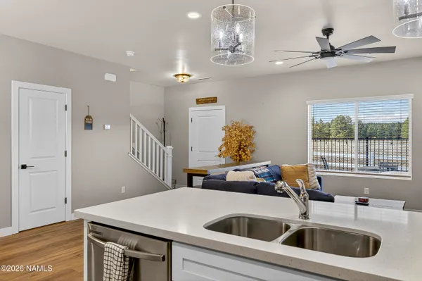 a kitchen with a sink a counter space and a chandelier