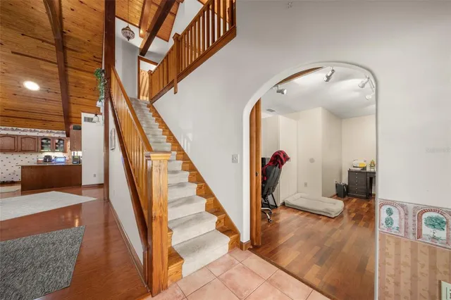a living room with wooden floor and stairs