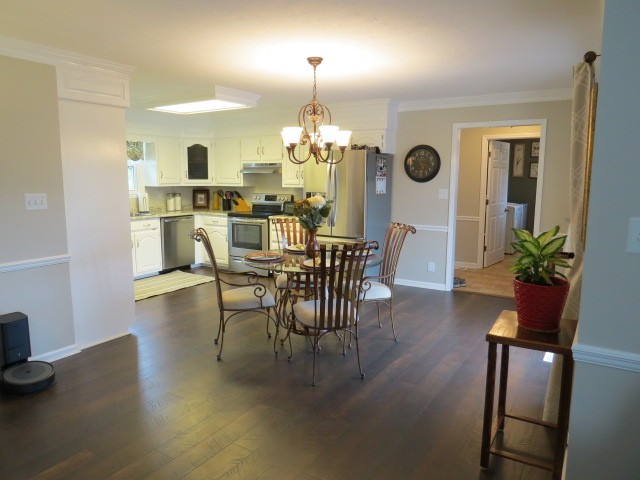 3286 Baugh Road Ardmore, TN 38449 - Photo 6 of 37 a dining room with furniture a chandelier and wooden floor