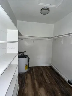 a room with a bench and cabinets
