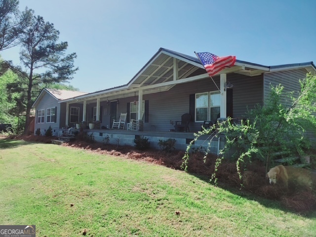 a front view of a house with yard and green space