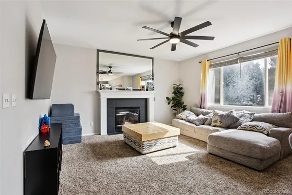 a living room with furniture and a fireplace