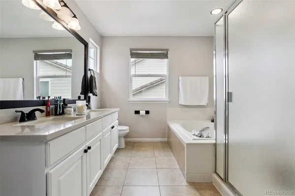 a bathroom with a granite countertop sink mirror and bathtub