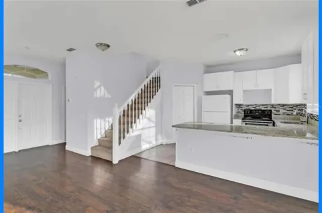 a view of a kitchen with wooden floor