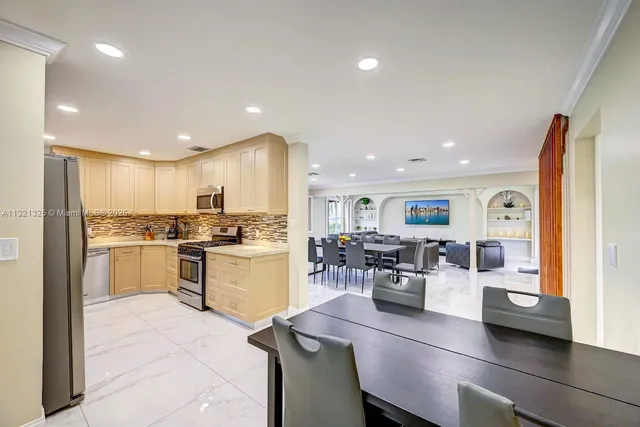 a kitchen with sink refrigerator and stove