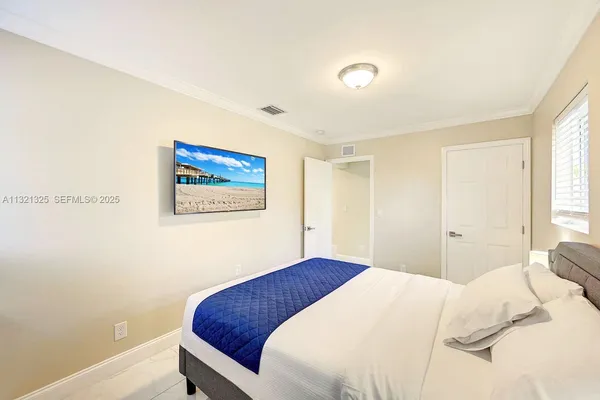 a bedroom with a bed and a wall painting