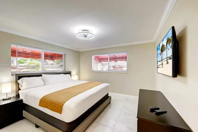 a bedroom with a bed and a flat screen tv