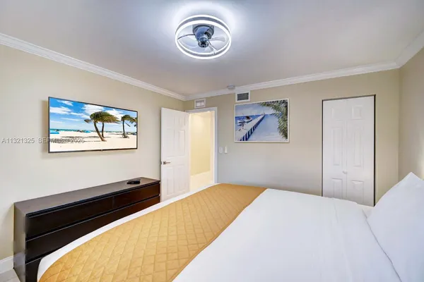 a bedroom with a bed and a painting on the wall