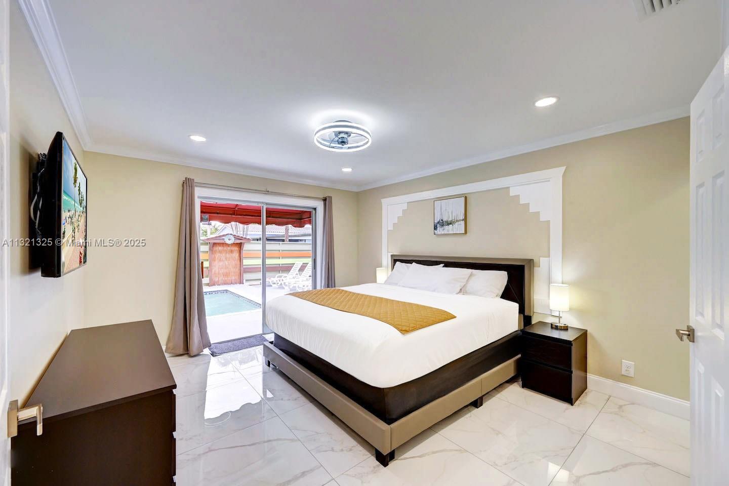 1020 North 13th Terrace Hollywood, FL 33019 - Photo 23 of 38 a bed sitting in a spacious bedroom next to a window