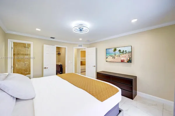 a bedroom with a bed and a painting on the wall