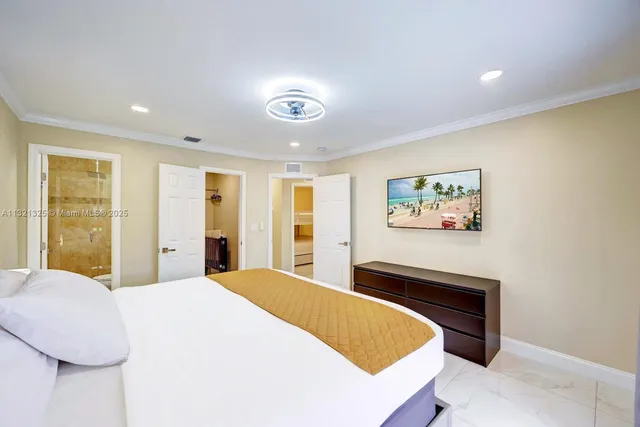 a bedroom with a bed and a painting on the wall