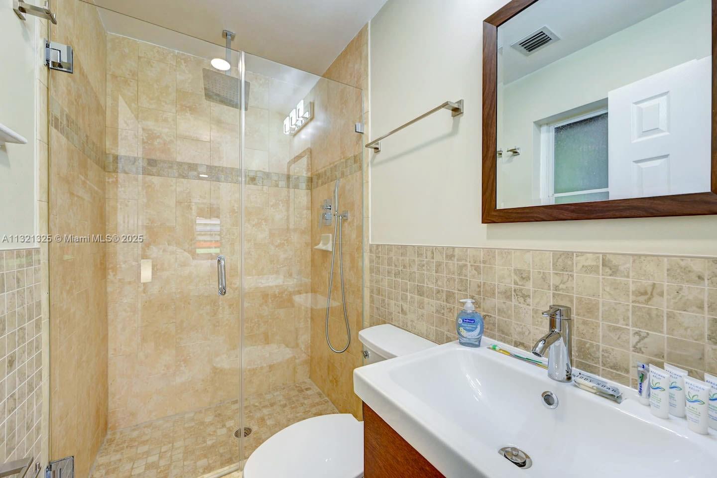 1020 North 13th Terrace Hollywood, FL 33019 - Photo 27 of 38 a bathroom with a sink mirror toilet and shower