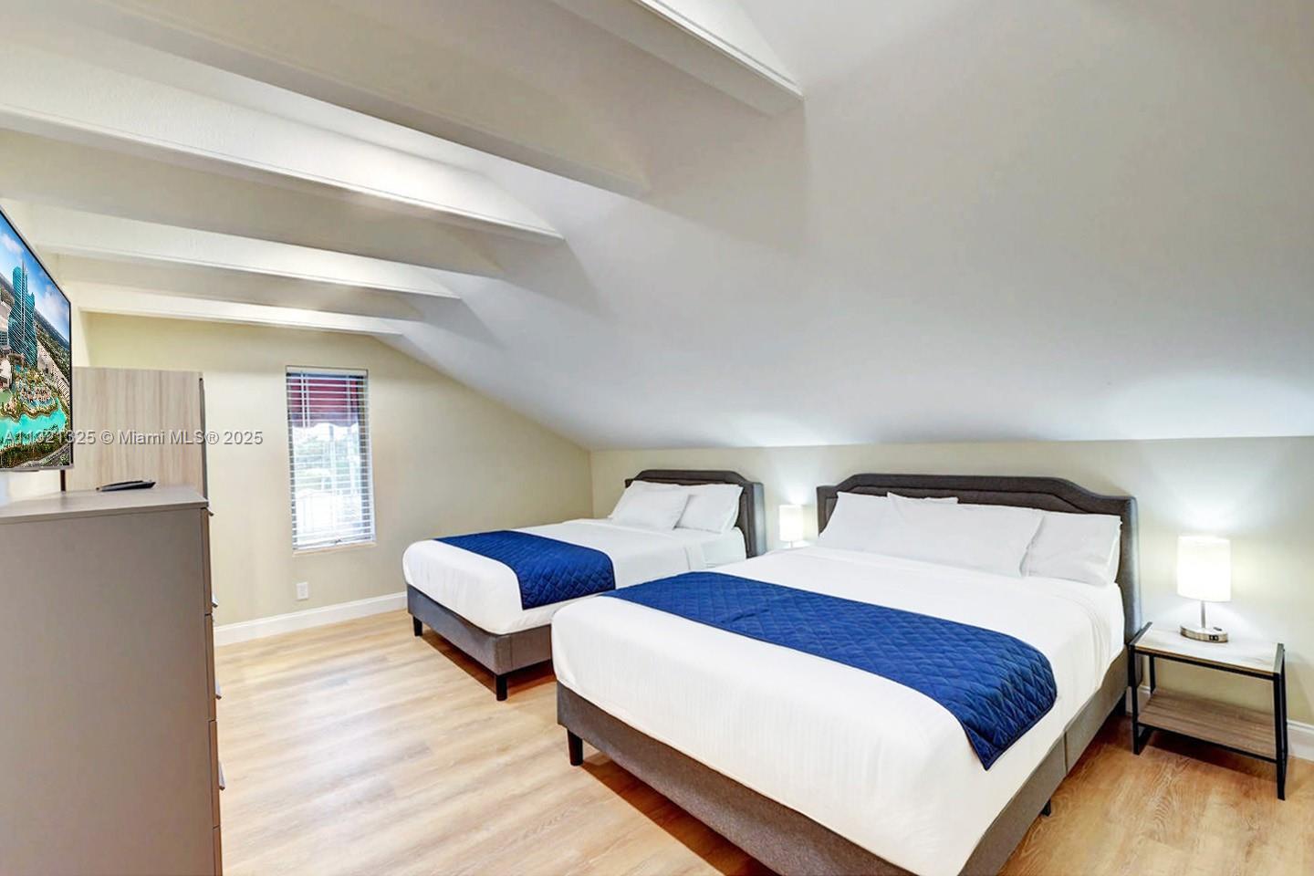 1020 North 13th Terrace Hollywood, FL 33019 - Photo 36 of 38 a bedroom with two beds and wooden floor