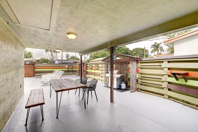 a dining room with furniture and a floor to ceiling window