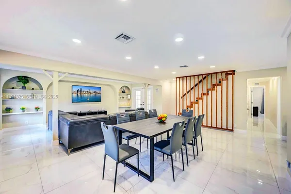 a view of a a dining room with furniture window and wooden floor