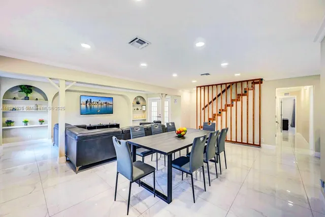 a view of a a dining room with furniture window and wooden floor
