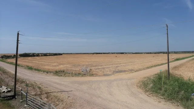 a view of a room with an empty space and wooden floor