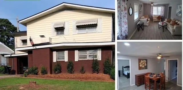 a view of a house with yard and chairs