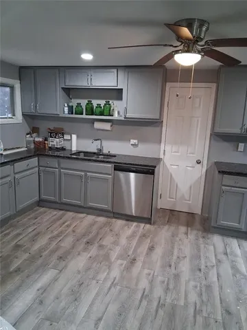 a kitchen with stainless steel appliances granite countertop a sink and cabinets