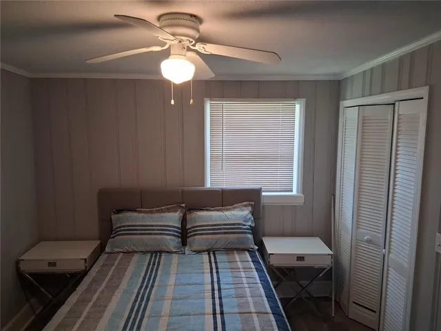 a bedroom with a bed and wooden floor