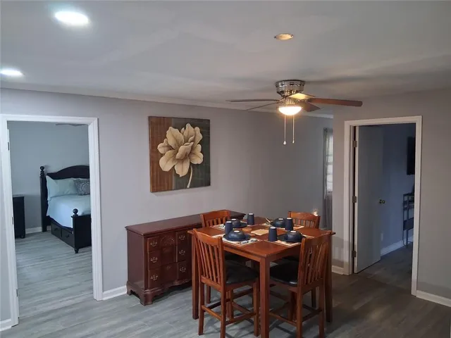 a dining room with furniture and wooden floor