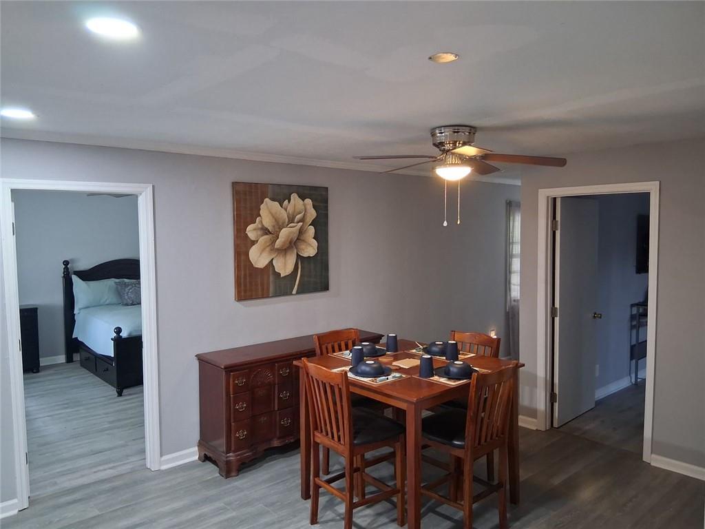 312 Magnolia Avenue Thomaston, GA 30286 - Photo 23 of 40 a dining room with furniture and wooden floor
