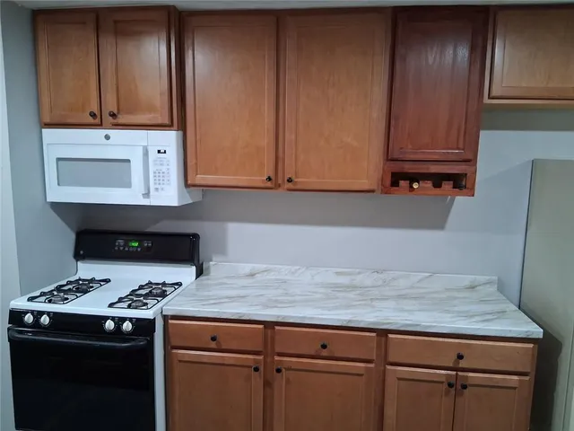 a kitchen with granite countertop cabinets and black appliances