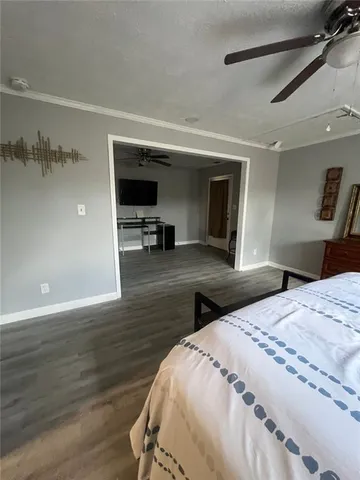 a bedroom with a bed and a television