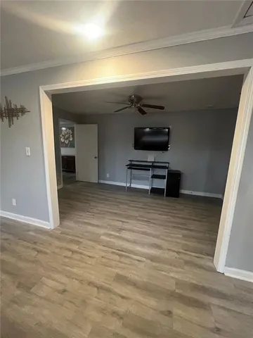 a view of a room with wooden floor