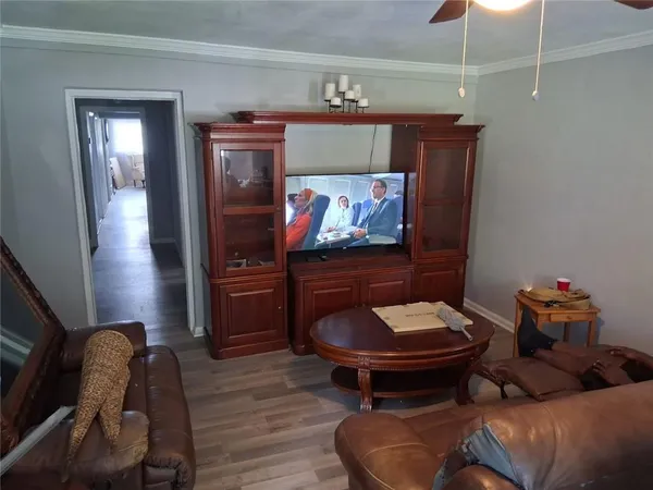 a living room with furniture and a wooden floor