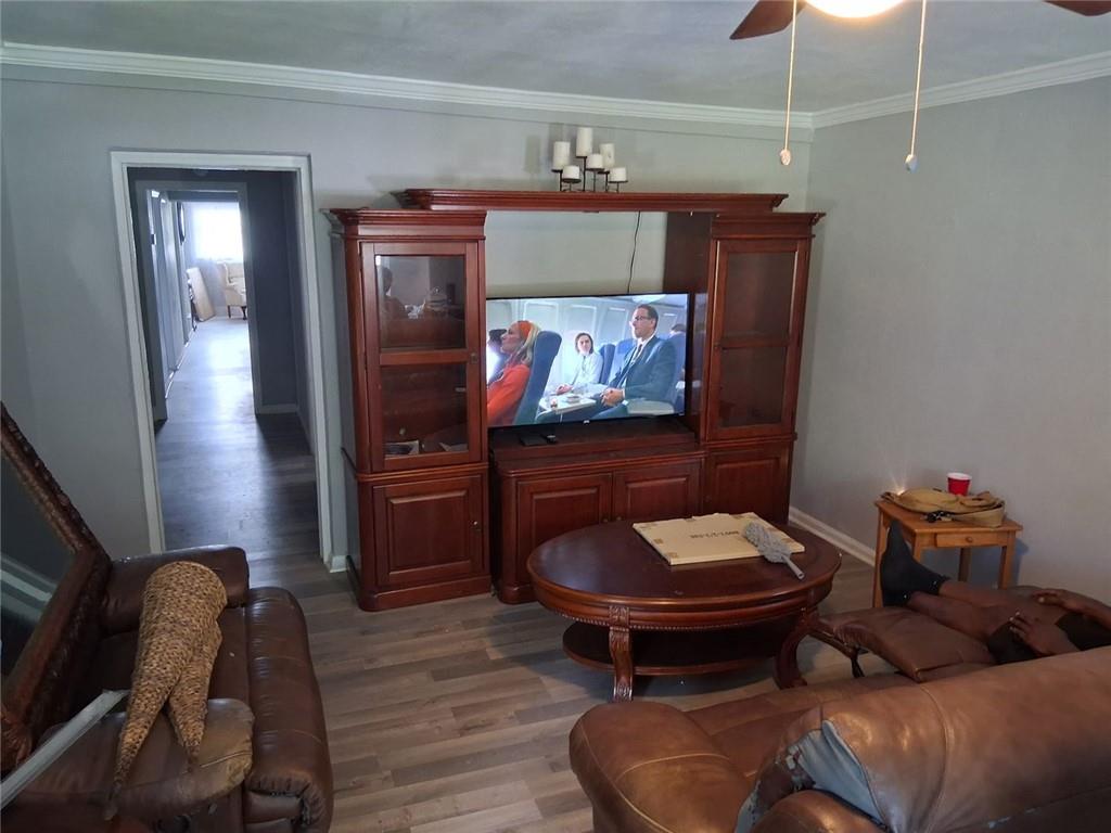 312 Magnolia Avenue Thomaston, GA 30286 - Photo 6 of 40 a living room with furniture and a wooden floor