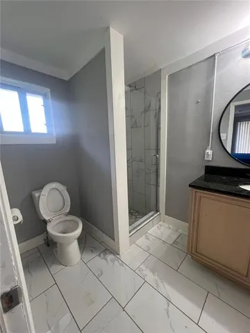 a bathroom with a toilet and a shower