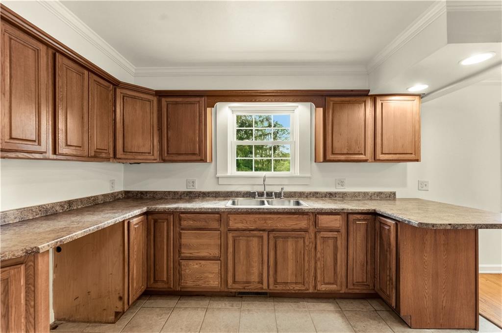 973 Blackhawk Road Beaver Falls, PA 15010 - Photo 12 of 36 a kitchen with a sink stove and cabinets