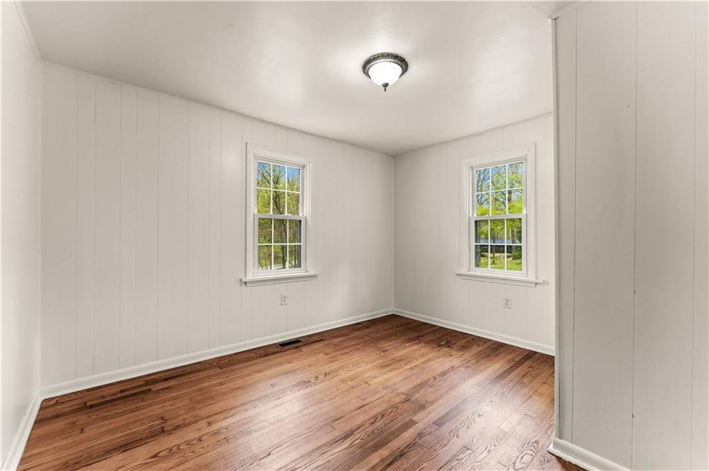 973 Blackhawk Road Beaver Falls, PA 15010 - Photo 16 of 36 an empty room with wooden floor and windows