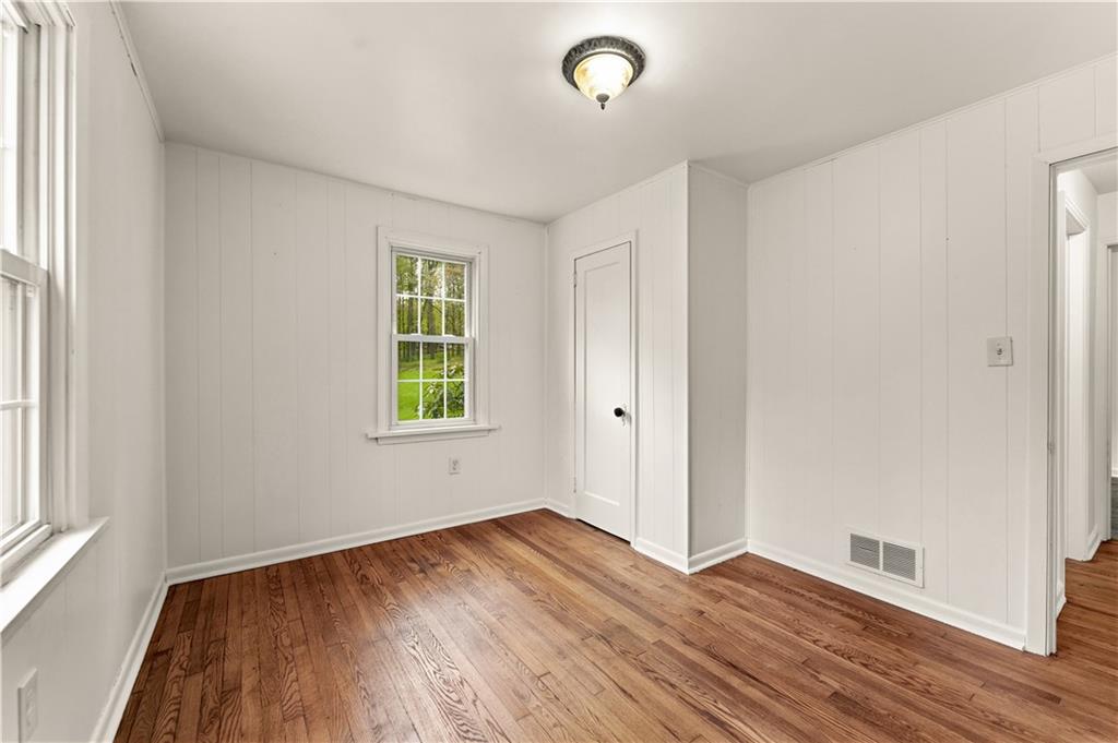 973 Blackhawk Road Beaver Falls, PA 15010 - Photo 17 of 36 an empty room with wooden floor and windows