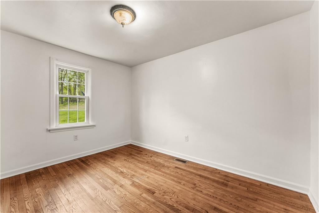 973 Blackhawk Road Beaver Falls, PA 15010 - Photo 18 of 36 wooden floor in an empty room with a window