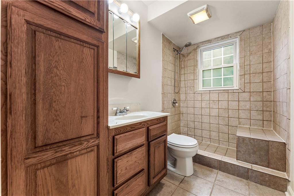 973 Blackhawk Road Beaver Falls, PA 15010 - Photo 20 of 36 a bathroom with a toilet a sink and a shower