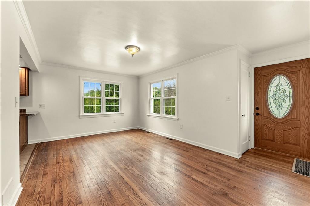 973 Blackhawk Road Beaver Falls, PA 15010 - Photo 3 of 36 an empty room with wooden floor and window