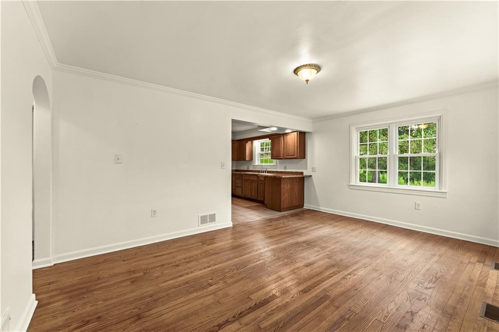 973 Blackhawk Road Beaver Falls, PA 15010 - Photo 4 of 36 an empty room with wooden floor and windows
