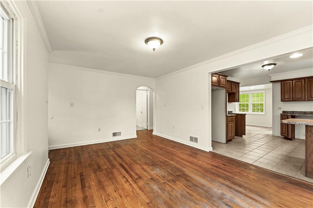 973 Blackhawk Road Beaver Falls, PA 15010 - Photo 5 of 36 a view of empty room with wooden floor and window