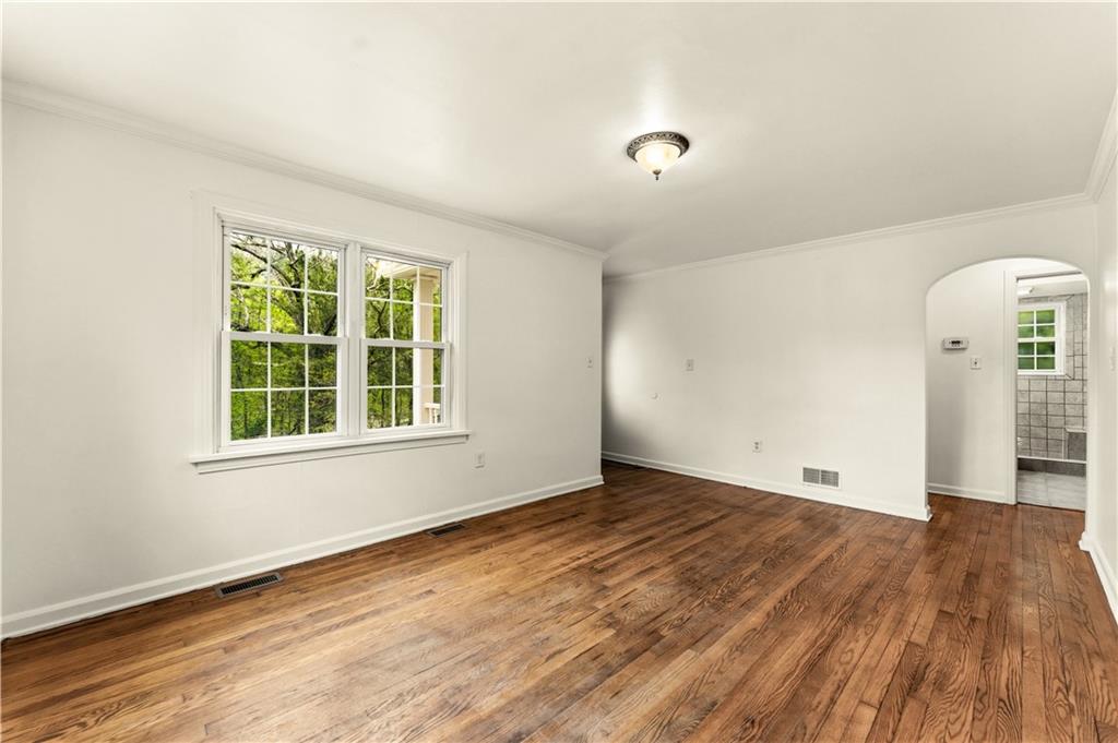 973 Blackhawk Road Beaver Falls, PA 15010 - Photo 6 of 36 a view of an empty room with wooden floor and a window