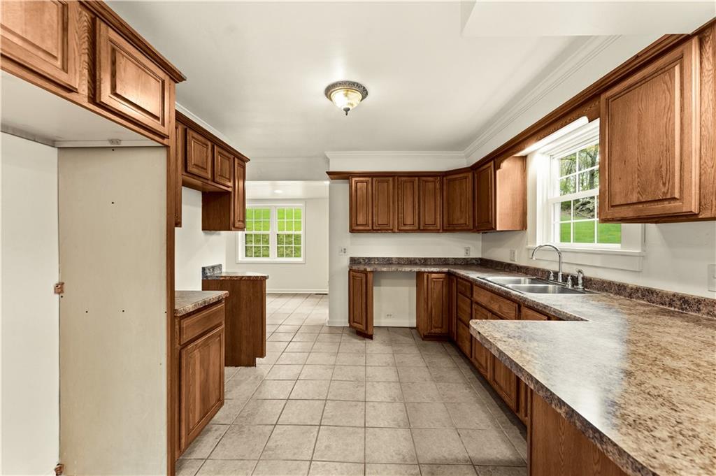 973 Blackhawk Road Beaver Falls, PA 15010 - Photo 7 of 36 a kitchen with granite countertop a stove sink and cabinets